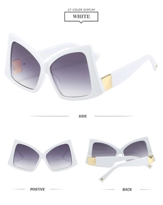 Detail view of white butterfly sunglasses with gold metal hinges and purple gradient lenses