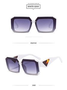 Detail view of bold white square frame sunglasses with grey gradient lenses and wide temples