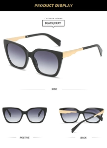 Detail view of cat eye sunglasses with black frames, gold temples and gradient lenses