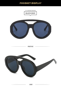 Front and side view of black oversized oval sunglasses with thick frames and dark lenses