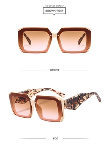 Detail view of square sunglasses with brown pink gradient lenses and tortoise shell temples