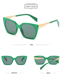 Detail view of square green sunglasses featuring elegant gold metal temples and frames