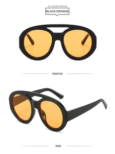 Detail view of large frame retro sunglasses with black frame and orange lenses