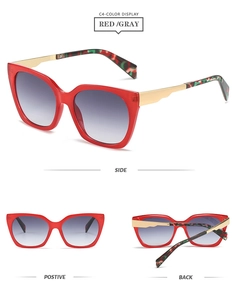 Detail of red cat-eye sunglasses with gray gradient lenses and gold tortoiseshell temples