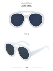 Detailed view of white oversized oval aviator sunglasses with a stylish double bridge design