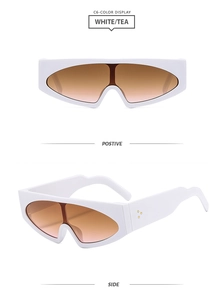 Detail view of white futuristic cat-eye sunglasses with tea gradient lenses and metal dots