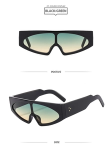 Detail view of futuristic oversized sunglasses with gradient lenses and gold rivets
