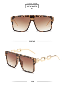 Detail view of brown tortoiseshell square sunglasses with gold metal chain temples