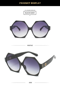 Detail view of hexagonal black frames with purple gradient lenses and gold ornaments