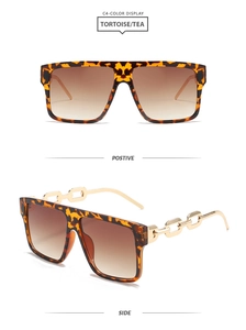 Detail of square tortoise shell sunglasses with golden chain metal temples and tea lenses