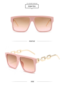 Detail of pink square sunglasses with gold metal chain temples and tea gradient lenses