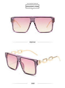 Detail of square oversized sunglasses featuring purple striped frames and gold chain temples