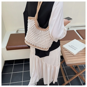 Detail of hand-woven crochet tote bag showing hollow texture and beige khaki contrast