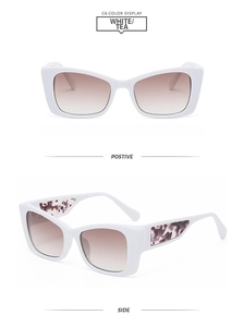 Detail view of cat-eye white sunglasses with tea gradient lenses and marble patterned temples