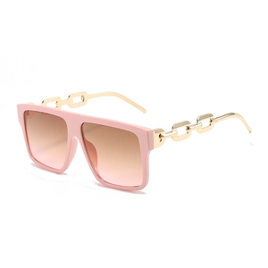 Fashionable oversized square sunglasses with pink gradient lenses and gold chain temples