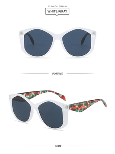 Detail of oversized geometric white sunglasses with colorful patterned temples