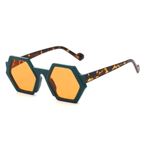 Fashionable hexagonal sunglasses with dark green frames, orange lenses and tortoiseshell temples