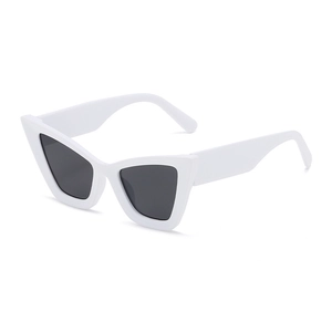 Futuristic white oversized cat-eye sunglasses with dark grey lenses in a minimalist style