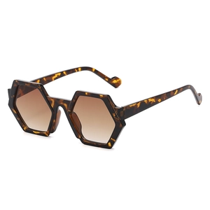 Chic hexagonal tortoiseshell sunglasses with brown gradient lenses at 45-degree angle