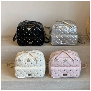 Detail showing four colors of quilted backpacks with star motifs and diamond studs