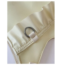 Detail of cream lace bow underarm bag showing textured fabric and silver D-ring