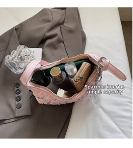 Detailed interior view of pink quilted handbag showing spacious storage for daily items