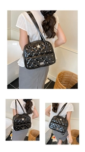 Detail of black quilted leather tote bag with star studs and twist lock on a model