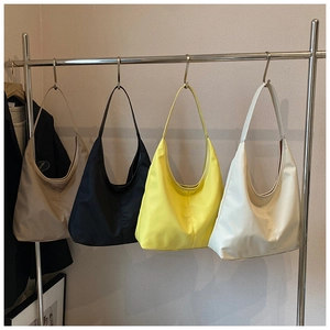 Detailed display of crescent hobo bags in four colors hanging on a silver metal rack