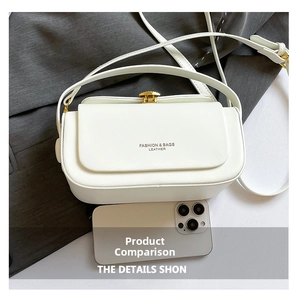 Detail of white leather shoulder bag featuring a gold shell clasp and brand lettering
