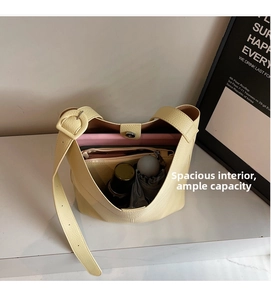 Top view of cream bucket bag showing spacious interior with tablet and accessories