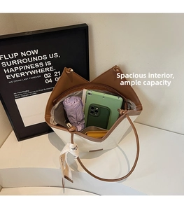 Top view of cream tote bag interior showing large capacity for tablet, phone, and umbrella