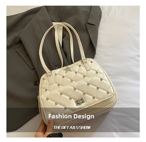 Detail of star-studded quilted bag with a silver rectangular twist-lock and cream leather