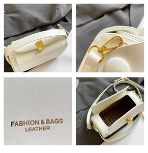 Detailed views of white lychee leather handbag with gold wavy hardware and striped interior