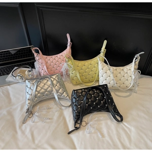 Detailed view of quilted bags with rhinestones, pearls and lace bow charms in five colors