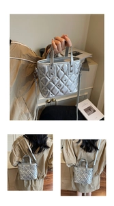 Close-up of silver quilted bucket bag with metallic rivets and adjustable strap