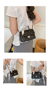 Close-up of black quilted crossbody bag featuring silver turn-lock and silk scarf handle