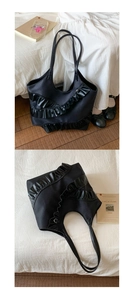 Close-up of black tote bag with lace ruffles and leather fold detail for daily commute