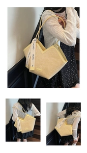 Detail of light yellow tote with pleated texture, V-shaped top and fashion ribbon detail