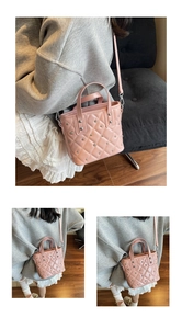 Detail of pink quilted bucket bag with silver studs and adjustable shoulder strap