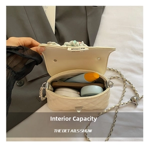 Interior view showing the storage capacity for phone and cosmetics in the quilted handbag