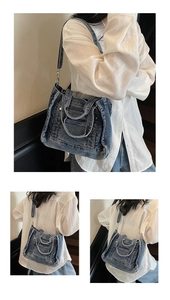 Detailed close-up of blue denim tote bag with frayed edges and adjustable strap