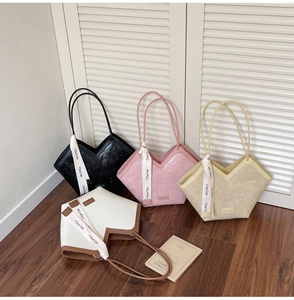Detail view of four textured tote bags with decorative silk scarves and V-shaped opening
