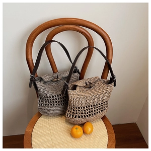 Detail of crochet woven straw bag featuring vintage wooden toggle closure and leather strap