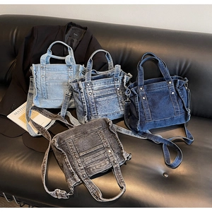 Detail shot of denim tote bags in four colors on a leather sofa with artistic props