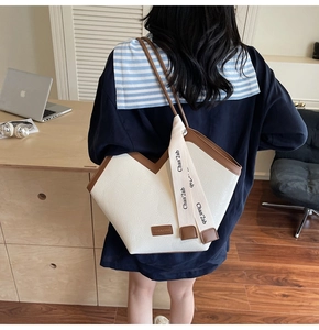 Detail of white lychee grain shoulder bag with brown leather straps and V-shaped cut