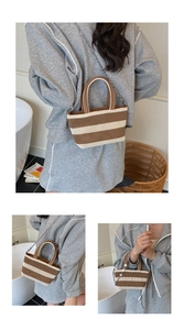 Detail of woven mini tote bag featuring brown and white stripes with a leather handle