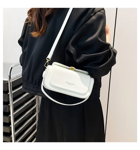 Detail of white vintage box bag showing the letter print and adjustable shoulder strap