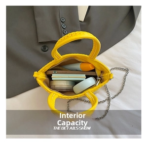 Internal capacity of yellow woven bag showing phone, lipstick, and makeup inside