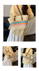 Detailed view of colorful paper rope weaving and brown leather handles on straw tote bag