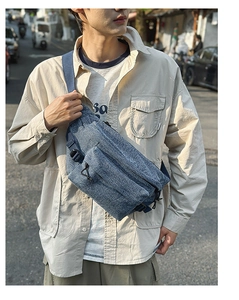 Macro detail of washed denim texture and tactical buckle on men's casual sling bag